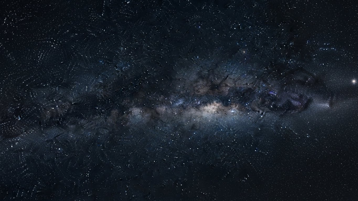 Wide view of the Milky Way galaxy in deep space, emphasizing the quiet vastness behind the Fermi Paradox and the lack of visible extraterrestrial civilizations.